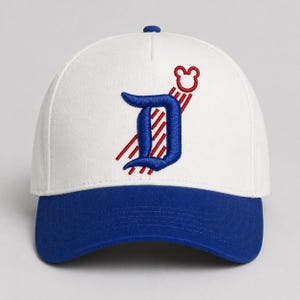 May include: A white baseball cap with a blue brim and a blue button on top. The cap features an embroidered blue letter "D" with red stripes and a red Mickey Mouse head.
