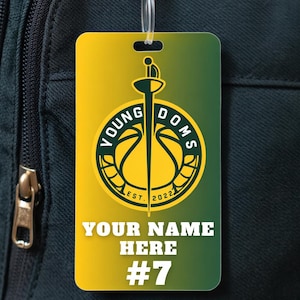 May include: A rectangular luggage tag with a yellow and green gradient. The tag features a logo with the text "YOUNG DOMS" and "EST. 2022". Below the logo is the text "YOUR NAME HERE" and the number "#7".