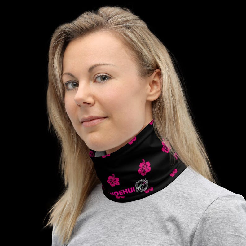 May include: A black neck gaiter featuring a repeating pattern of vibrant pink hibiscus flowers and the white text "YNDEHUI" printed near the bottom edge. The fabric is smooth and form-fitting, covering the neck area with a seamless design.