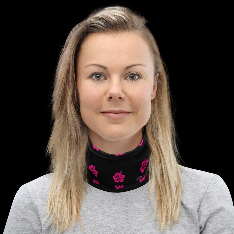 May include: A black neck gaiter featuring a repeating pattern of small, vibrant pink hibiscus flowers. The fabric is smooth and form-fitting, designed to cover the neck area completely with a consistent floral print throughout the entire surface.
