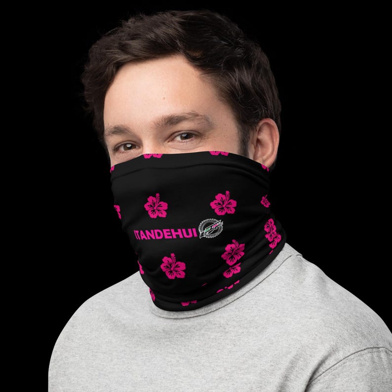May include: A black neck gaiter featuring a repeating pattern of bright pink hibiscus flowers. The text ITANDEHUI is printed in pink on the front, accompanied by a circular logo graphic containing the letters EP in a stylized font design.