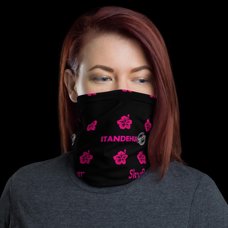 May include: A black neck gaiter featuring a repeating pattern of bright pink hibiscus flowers. The text ITANDEHUI is printed in pink across the center, with the word Sky printed in pink near the bottom edge of the fabric face covering.