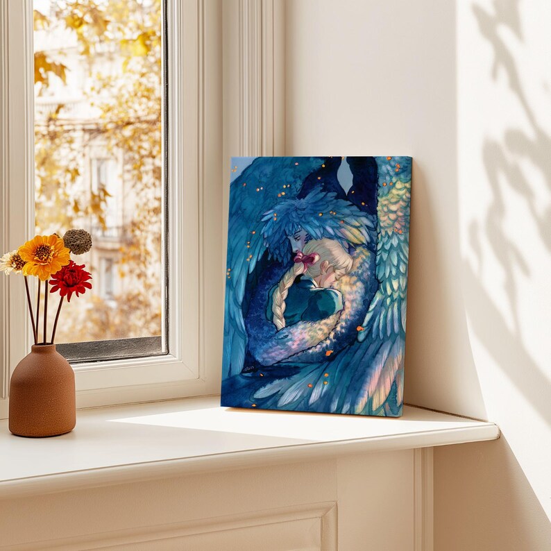 May include: A canvas print featuring a watercolor illustration of two figures embracing, surrounded by blue and teal feathered wings. The artwork has a fantasy theme, with soft colors and a romantic feel. The print is displayed on a white windowsill.