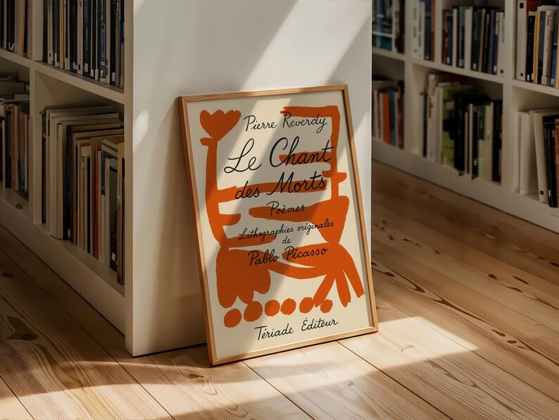 May include: A framed poster with an orange abstract design and the text "Pierre Reverdy Le Chant des Morts Poemes Lithographies originales de Pablo Picasso  Triaide Editeur".