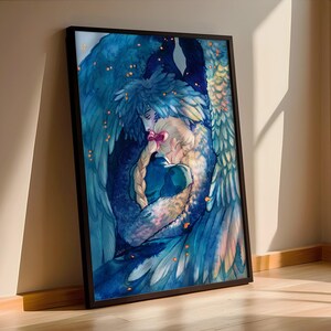 May include: A framed art print featuring a watercolor illustration of two figures embracing. One figure has blue feathered wings, and the other has long blonde hair with a pink bow. The artwork is predominantly blue with accents of gold and is set against a light background.