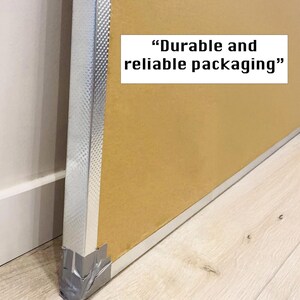 May include: Close-up of a cardboard box with a silver edge and tape. The box is labeled "Durable and reliable packaging."