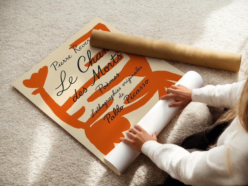 May include: A beige poster with orange abstract shapes and black text. The text reads "Pierre Reverdy Le Chant des Morts Poemes Lithographies originales de Pablo Picasso".