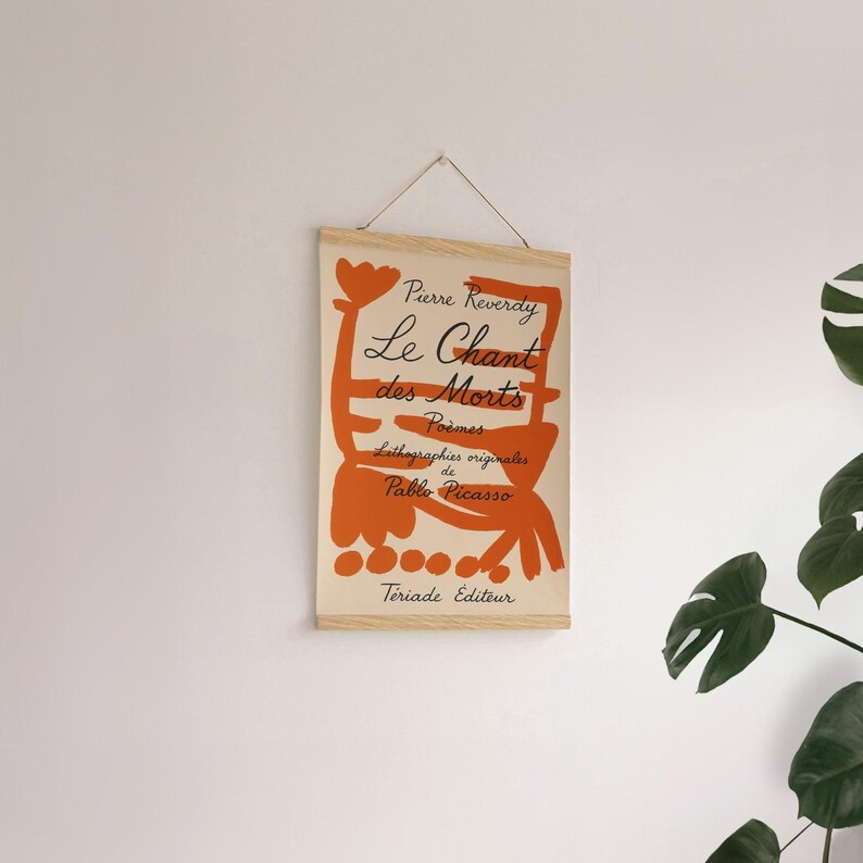 May include: A beige canvas print with an orange abstract design and black text. The text reads "Pierre Reverdy Le Chant des Morts Poemes Lithographies originales de Pablo Picasso  Teriade Editeur".