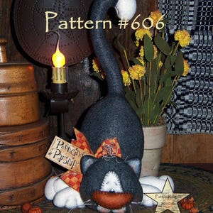 May include: A black and white cat with a white face and a black nose is lying down with its head resting on its paws. The cat is wearing a red and white plaid bow. The cat is sitting on a brown rug with a yellow flower in the background. The image also includes a sign that says "Pouncing Parsnip" and a star with the text "Pattie Rabb 2010".