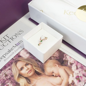 breastmilk jewelry DIY kit box with instructions, and ring made in a ring box outside of the purple diy kit box for breastmilk jewelry keepsakes from KeepsakeMom