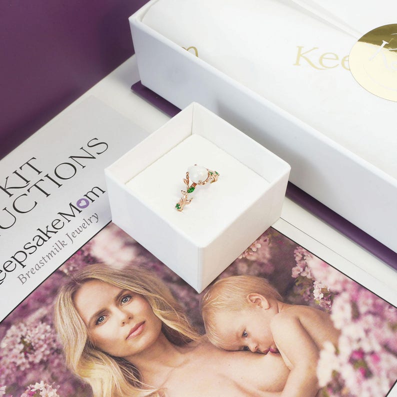 breastmilk jewelry DIY kit box with instructions, and ring made in a ring box outside of the purple diy kit box for breastmilk jewelry keepsakes from KeepsakeMom