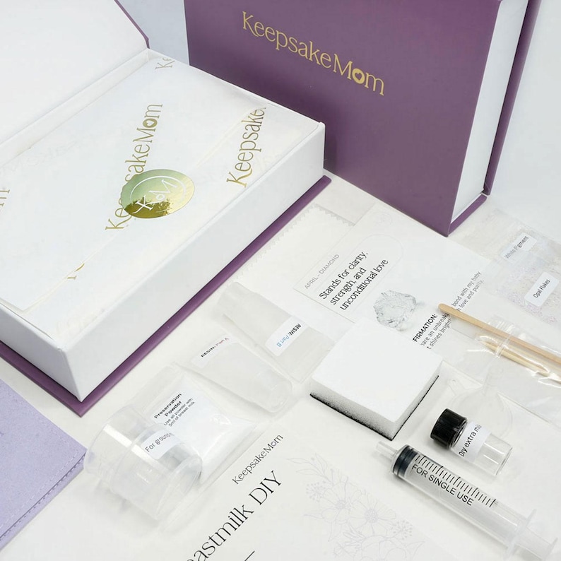 breastmilk jewelry DIY kit box with instructions, measuring and mixing tools, resin and syringe outside of the purple diy kit box for breastmilk jewelry keepsakes from KeepsakeMom