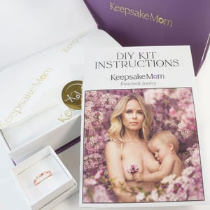 breastmilk jewelry DIY kit box with instructions, and ring made in a ring box outside of the purple diy kit box for breastmilk jewelry keepsakes from KeepsakeMom