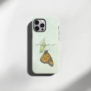 May include: A light green phone case featuring a watercolor illustration of a monarch butterfly with orange and black wings. The case has the text "He's not finished with me yet" and Psalm 138:8.