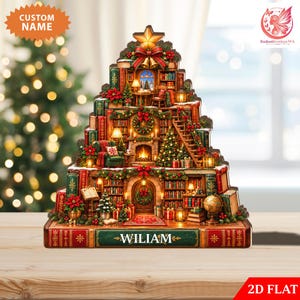 May include: A decorative wooden display shaped like a Christmas tree, featuring a detailed library scene with bookshelves, a fireplace, and a ladder. The base is a large red book with the name WILIAM printed in white letters on a green panel.