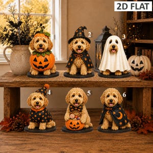 May include: Six golden-coloured dog figurines dressed in Halloween costumes, including a pumpkin, a witch hat and cape, a ghost sheet, a polka dot party hat, a pumpkin bucket, and a moon and star cape, all displayed on individual circular bases.