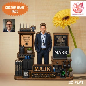 May include: A wooden desk-themed 2D flat art piece with a man's image, a yellow flower, and text. The desk has a laptop, mug, and phone. Text includes "MARK", "IT DAD - LEADER - HERO", and "You keep our world connected".