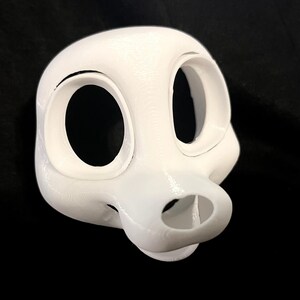 May include: A white 3D-printed mask with large, oval eye openings and a rounded snout. The mask has a smooth texture and is designed to fit over the face. The mask is likely for cosplay or costume use.