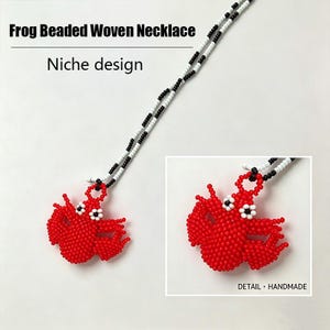 May include: A beaded woven necklace featuring a red frog pendant. The frog pendant is made of small red beads with white and black accents. The necklace cord is black and white beaded. Text on the image reads "Frog Beaded Woven Necklace" and "Niche design."