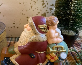 Folk Art Chalkware Santa from Chocolate Mold on Sled with Angel