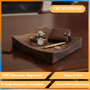 May include: A dark wooden tray with a curved design displays a brown leather wallet, a wristwatch with a brown strap, a gold pen, and coins. The tray sits on a dark brown surface. The image includes the text "CNC ROUTER FILE".