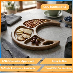 May include: A crescent moon-shaped wooden serving tray with three distinct compartments. The tray contains a pile of almonds, several square cheese slices, round crackers, and a few olives. The text CNC ROUTER FILE is visible.