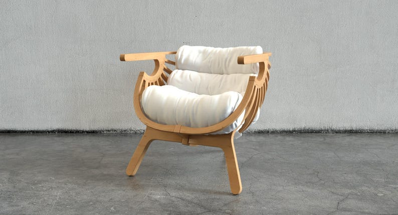 May include: A contemporary wooden armchair with a curved back and armrests. The chair has a light wood frame and two white, rectangular cushions for the seat and back. The chair is set against a neutral grey wall.