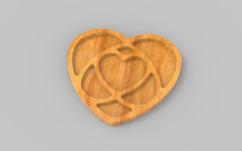 May include: Wooden heart-shaped serving tray with a nested heart design. The tray is made of light-coloured wood and features a carved-out heart shape in the centre, surrounded by a larger heart outline. Ideal for serving snacks or as a decorative piece.
