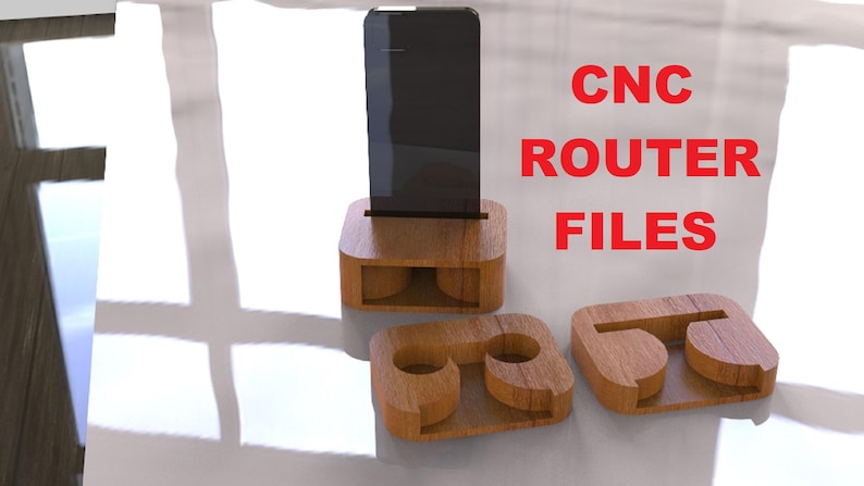 May include: Wooden phone stand with a slot for a phone, and two additional wooden pieces. The stand is made of light brown wood. The text "CNC ROUTER FILES" is in red.