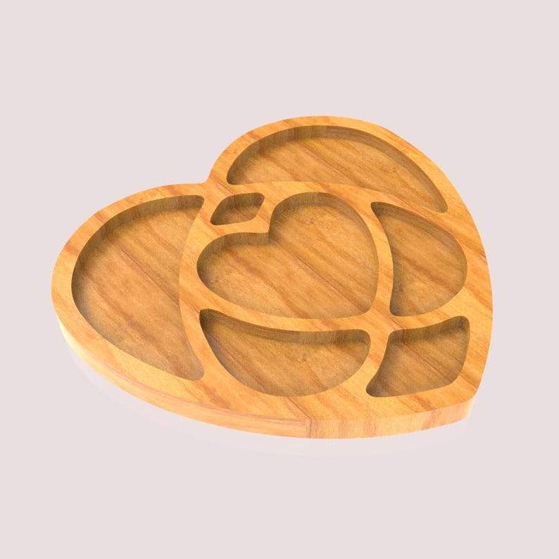 May include: A heart-shaped wooden serving tray with multiple compartments. The tray is made of light-coloured wood and features a heart-shaped design in the centre, surrounded by other heart-shaped and curved sections. The tray is ideal for serving snacks or appetizers.