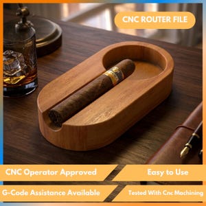 Puede incluir: Un cenicero de madera marrón claro con un cigarro. El cenicero tiene un diseño curvo. El texto "CNC ROUTER FILE" es visible. El texto adicional incluye "CNC Operator Approved", "Easy to Use", "G-Code Assistance Available" y "Tested With Cnc Machining".