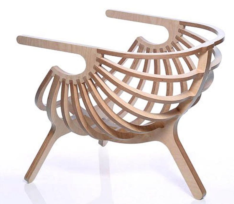 May include: A light-coloured wooden chair with a distinctive, open design. The chair has curved wooden slats forming the back and seat, supported by angled legs. The armrests extend outwards, creating a modern, artistic aesthetic.