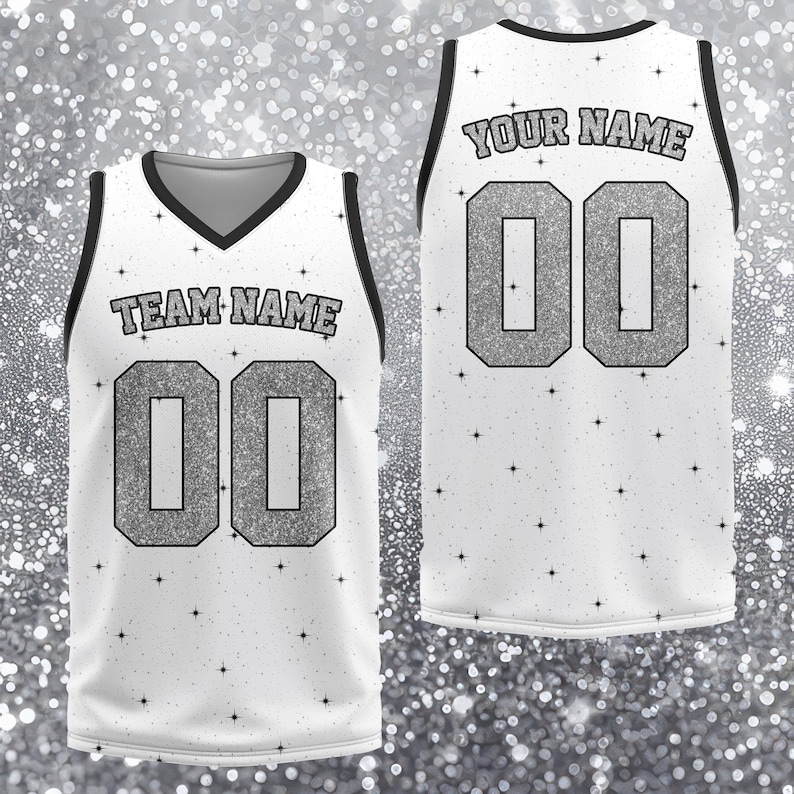 May include: White athletic jersey with black trim and a V-neck. The front displays "TEAM NAME" above the number "00" in silver glitter. The back shows "YOUR NAME" above the number "00". Small black stars are scattered across the jersey.