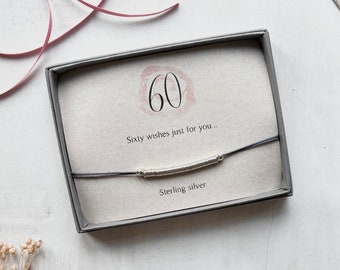 Special 60th Birthday charm bracelet with special message featuring sterling silver links on adjustable cord bracelet.