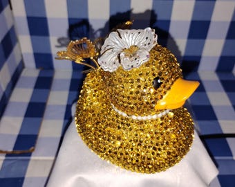 Hermoso patito de goma con forma de mariposa dorada y brillantes