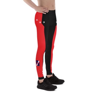 May include: Red and black athletic leggings with a white paw print design and a blue, red and white logo on the left leg.