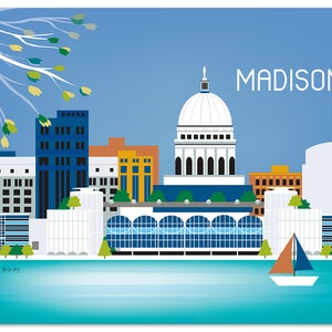 Puede incluir: Una ilustración colorida del horizonte de Madison, Wisconsin, que presenta el edificio del capitolio estatal con una cúpula blanca, un lago azul y un velero. El texto "MADISON" está en letras blancas en la parte superior de la imagen.
