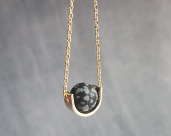 Matte Black Stone Necklace, eclipse necklace, snowflake obsidian necklace, spotted obsidian pendant, gold semicircle, modern half circle orb