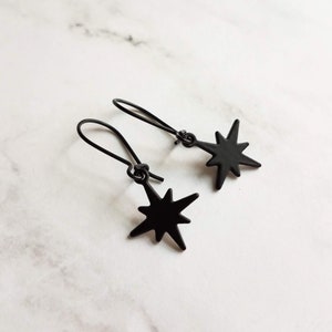 Black Star Earrings, small matte black sunburst charm, latching kidney hooks, night earrings, celestial earring starburst earring north star