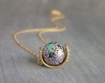 Moon Necklace, metallic stone pendant, lava stone necklace, iridescent rainbow, gold half circle eclipse, pitted stone crater, jewel peacock