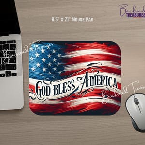 May include: A mouse pad with a patriotic design featuring the American flag in red, white, and blue. The text "God Bless America" is prominently displayed. The mouse pad measures 8.5" x 7.1".