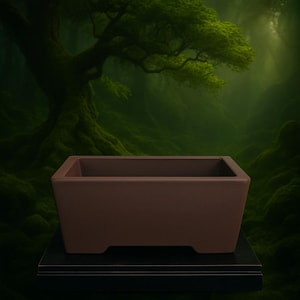 May include: A rectangular brown bonsai pot with a slightly flared base. The pot is made of a solid material and sits on a black surface. The background features a lush green forest scene.