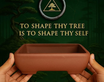 May include: A rectangular, brown bonsai pot with a low profile, held by hands. The image features the text "TO SHAPE THY TREE IS TO SHAPE THY SELF" and a gold emblem with a tree inside a triangle.
