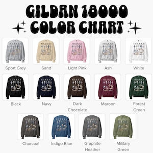 K&ouml;nnte beinhalten: Eine Gildan 18000 Farbkarte mit vierzehn Rundhals-Sweatshirts in verschiedenen Farben, darunter Sportgrau, Sand, Hellrosa, Asche, Wei&szlig;, Schwarz, Marineblau, Dunkelschokolade, Kastanienbraun, Waldgr&uuml;n, Anthrazit, Indigoblau, Graphit-Melange und Milit&auml;rgr&uuml;n.