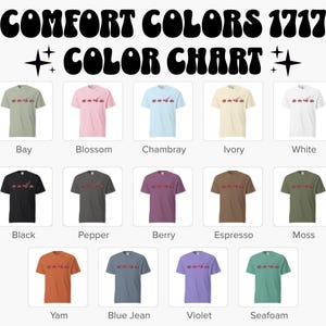 May include: A colour chart showing Comfort Colors 1717 t-shirts in a range of shades. The shirts are arranged in rows and columns, each displaying a different colour. The colours include Bay, Blossom, Chambray, Ivory, White, Black, Pepper, Berry, Espresso, Moss, Yam, Blue Jean, Violet, and Seafoam.