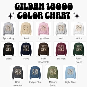 May include: A Gildan 18000 color chart displaying thirteen crewneck sweatshirts in various colors including sport grey, sand, light pink, ash, white, black, navy, dark chocolate, maroon, forest green, dark heather, indigo blue, military green, and light blue.