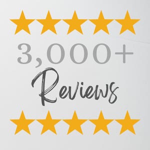 May include: A graphic featuring two horizontal rows of five yellow stars, with the text 3,000+ in grey and the word Reviews in a dark grey script font centered between the star rows, all set against a plain, light-colored background.