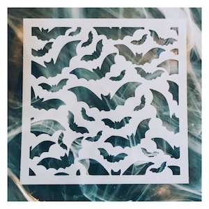 May include: White stencil with a repeating pattern of bats. The stencil is made of a thin, flexible material and is perfect for creating Halloween decorations.