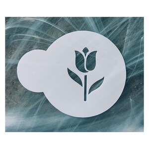 May include: A white stencil featuring a tulip design. The stencil is circular with a cloud-shaped extension on the left side. The tulip has a detailed flower head, stem, and leaves. The stencil is designed for crafting and decorative purposes.