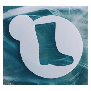 May include: A white stencil of a rain boot on a blue background.